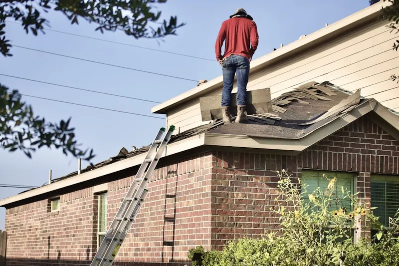Professional roofer working on a residential roof in Half Acre